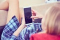 Back view of a woman hands using smart phone with blank screen close up. White phone with a black screen in the hands of Royalty Free Stock Photo