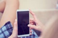 Back view of a woman hands using smart phone with blank screen close up. White phone with a black screen in the hands of Royalty Free Stock Photo