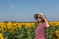 Back view of woman in hat looking at sunflower Royalty Free Stock Photo