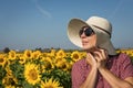 Back view of woman in hat looking at sunflower Royalty Free Stock Photo