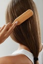 Back View Of Woman With Healthy Long Hair Brushing It With Brush Royalty Free Stock Photo