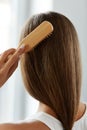 Back View Of Woman With Healthy Long Hair Brushing It With Brush Royalty Free Stock Photo