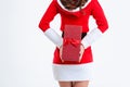 Back view of woman holding christmas gift behind back Royalty Free Stock Photo