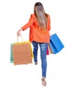 Back view of a woman jumping with shopping bags. Royalty Free Stock Photo