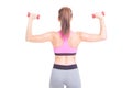 Back view of woman lifting pair of dumbbells