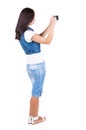 Back view of woman photographing. Royalty Free Stock Photo