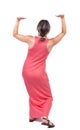 Back view of woman protects hands from what is falling from abo Royalty Free Stock Photo