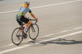 Back view of a woman riding her street racing bike on a road Royalty Free Stock Photo