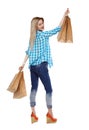 Back view of woman with shopping bags .