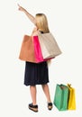 Back view of woman with shopping bags pointing . Royalty Free Stock Photo