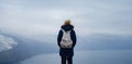 Back view of woman on shore of North sea on cold winter day. Royalty Free Stock Photo