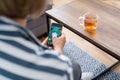 Back view woman sitting on the couch and holding smartphone with active online mobile application with Healthy diet Royalty Free Stock Photo