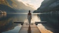 Back view of a woman standing on a boardwalk at a lake Royalty Free Stock Photo