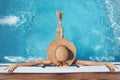 Back view of woman in straw hat relaxing in swimming pool on Tropical Resort. Exotic Paradise. Travel, Tourism and Vacations Royalty Free Stock Photo