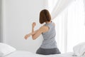 Back of view Woman stretching her arm after wake up on bed Royalty Free Stock Photo