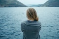 Back view of woman thinking alone and watching the sea with the Royalty Free Stock Photo