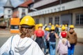 Back view woman tourist wear yellow safety helmet equipment at Rammelsberg Unesco Mine trip entrance group tour. Tourism Royalty Free Stock Photo