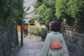 Back view of a woman in a traditional Japanese dress & x28;kimono& x29; walking down the street in Japan,Kyoto Royalty Free Stock Photo