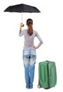 Back view of woman with umbrella traveling with suitcas. Royalty Free Stock Photo