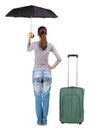 Back view of woman with umbrella traveling with suitcas. Royalty Free Stock Photo