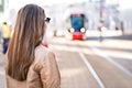 Back view of woman waiting for tram in stop Royalty Free Stock Photo