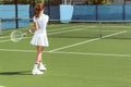 back view of woman in white tennis uniform playing tennis