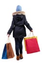 Back view of a woman in a winter jacket that comes with paper shopping bags Royalty Free Stock Photo