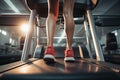 Back view of women feet and legs running on treadmill in fitness studio