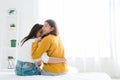 Back view of women lesbian happy couple waking up in morning, sitting on bed, stretching in cozy bedroom. Royalty Free Stock Photo