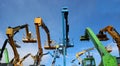 Back view of work aerial platforms booms and other construction machinery Royalty Free Stock Photo