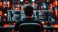 Back View of IT Worker Sitting at Desk and Working on Computer - Programmer or Coder Engaged in Programming Tasks