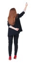 Back view of writing beautiful redhead business woman. Royalty Free Stock Photo