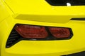 Back view of a yellow sport car Chevrolet Corvette Z06. Car exterior details