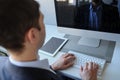 lateral view of a young man working on the computer