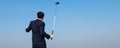 Back view of Young Asian CEO Businessman wearing suits playing golf at the golf course. Portrait of Asian businessman. sucess and