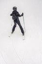 Back view of young athlete on skis, ski slope, blurred selective focus. Winter sport Royalty Free Stock Photo