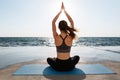 Back view of young attractive girl practicing yoga sitting in pa Royalty Free Stock Photo