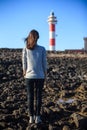 Back view of young beautiful woman enjoying lighthouse