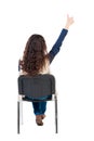 Back view of young beautiful woman sitting on chair and thumbs Royalty Free Stock Photo