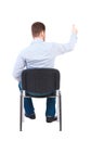 Back view of young business man sitting on chair and thumbs up. Royalty Free Stock Photo