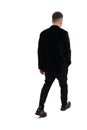 Back view of a young business man walking, isolated on white background Royalty Free Stock Photo
