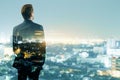 Back view of young businessman silhouette looking into the distance on creative night city background with mock up place. Future, Royalty Free Stock Photo