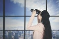 Young businesswoman looks at city with binoculars Royalty Free Stock Photo