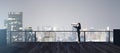 Back view of young businesswoman with telescope looking into the distance on rooftop with night sky and wide city view. Success,