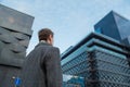 Back view of young confident man leader standing near the office building. Bottom view Royalty Free Stock Photo