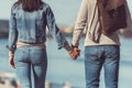 back view of young couple holding hands outdoors Royalty Free Stock Photo