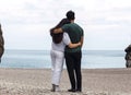 Back view of a young couple hugging ina a canyon in front of the sea Royalty Free Stock Photo