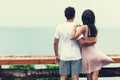 Back view of young couple standing at the top and watching seaview Royalty Free Stock Photo