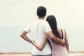 Back view of young couple standing at the top and watching seaview Royalty Free Stock Photo
