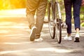 Back view of young couple walking together with bicycle Royalty Free Stock Photo